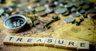 Vintage treasure hunting concept with coins and compass