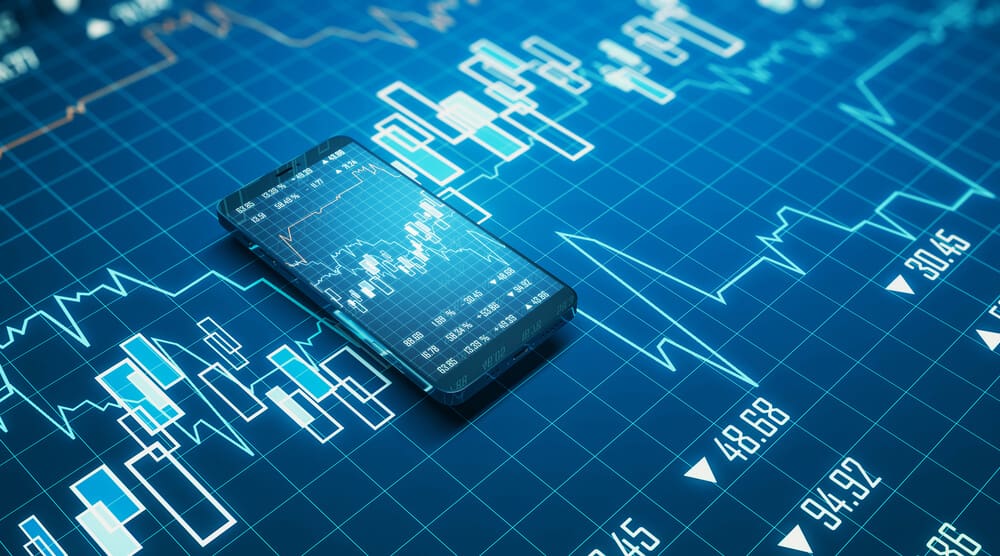 relação entre o open finance e as criptomoedas representada por celular com gráficos financeiros complementados pelo fundo da imagem
